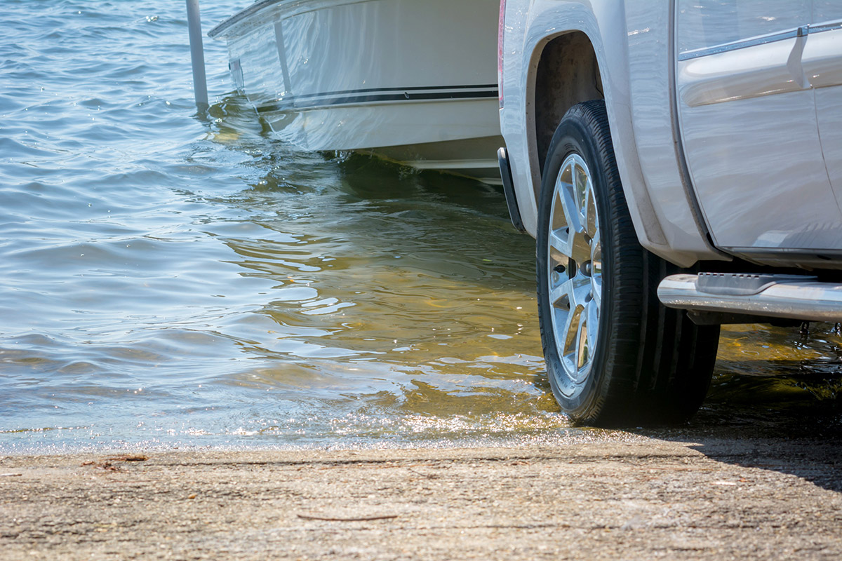 Backing a boat into water at boat ramp